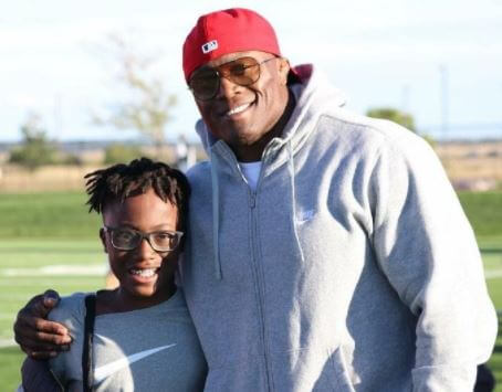 Myles Lashley with his father Bobby Lashley on the field.
